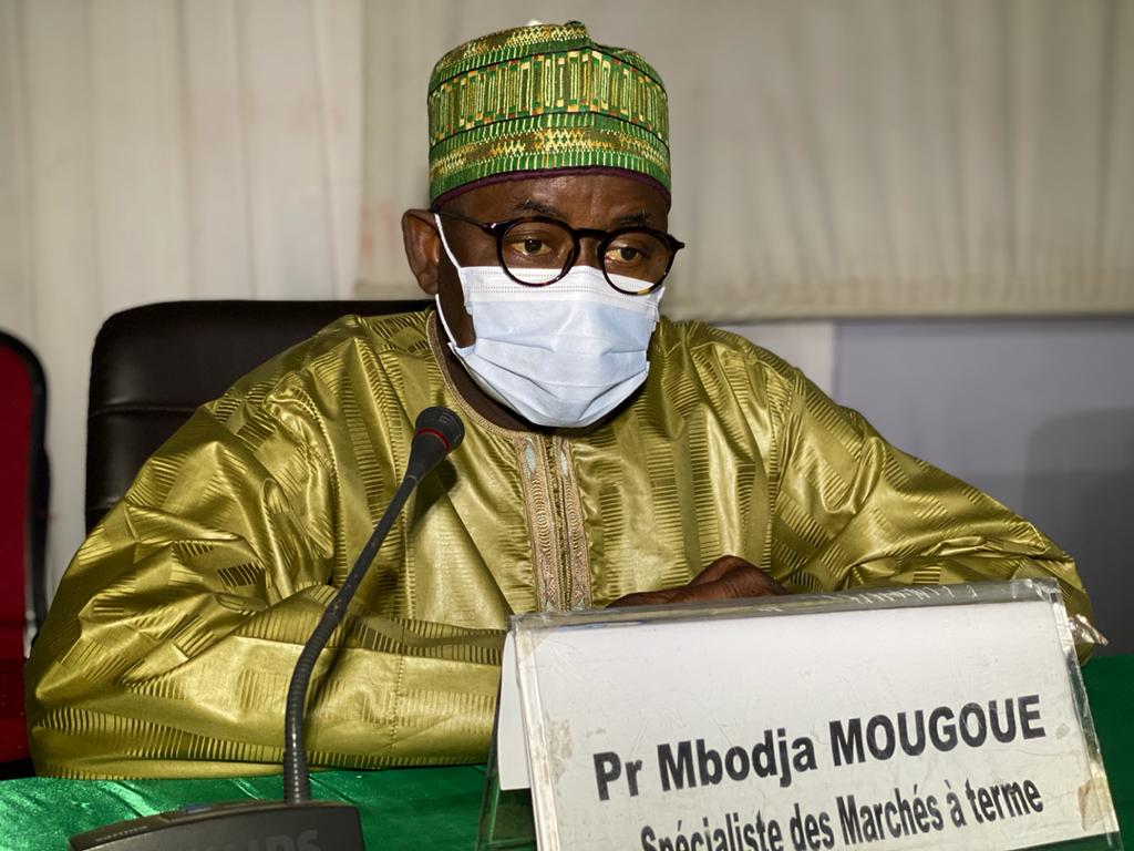 Professor Mbodja Mougoue sitting at a table with a microphone 